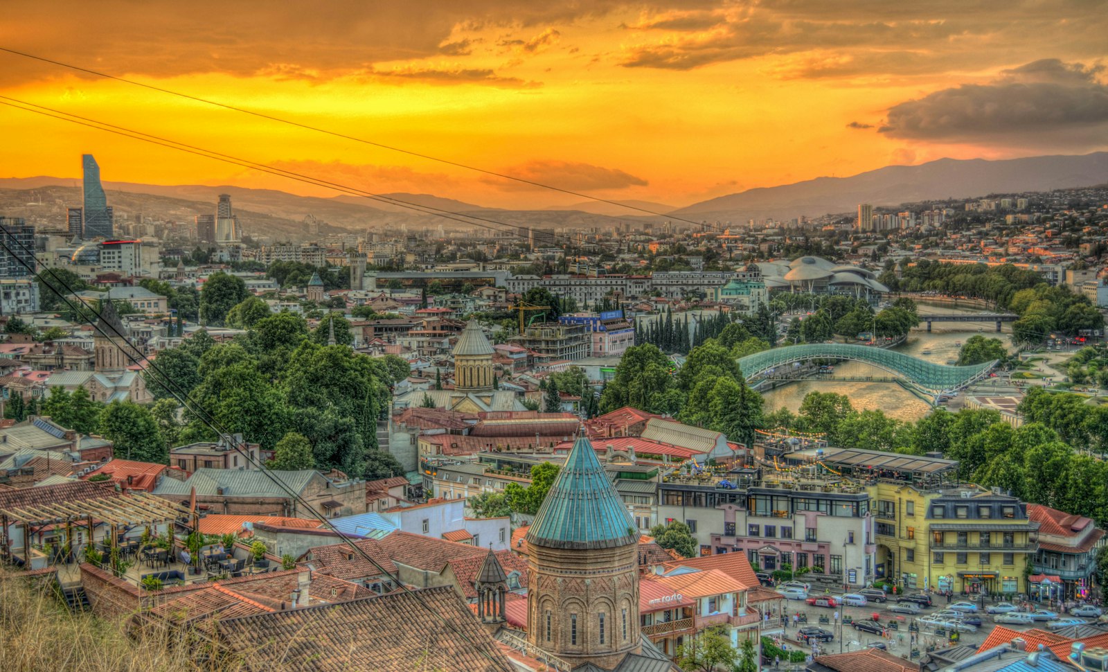 Tbilisi skyline at sunset, with the Bridge of Peace over the Mtkvari